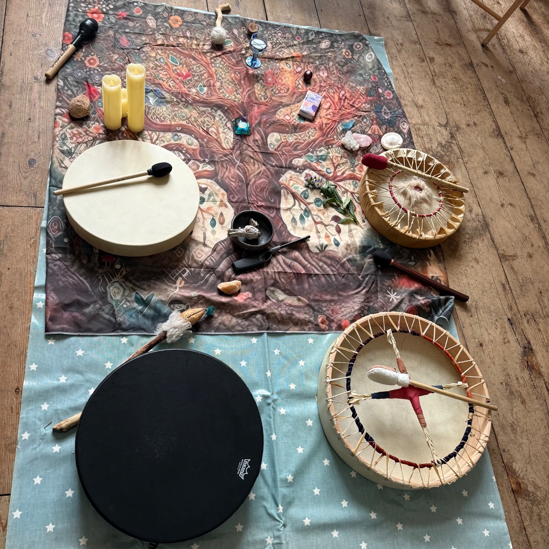 Drums, candles and a tree-of-life altar cloth laid out for the women's drum ceremony